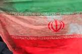 تصویر خانم شهیده در روز جهانی قدس به همراه پرچم خونین
